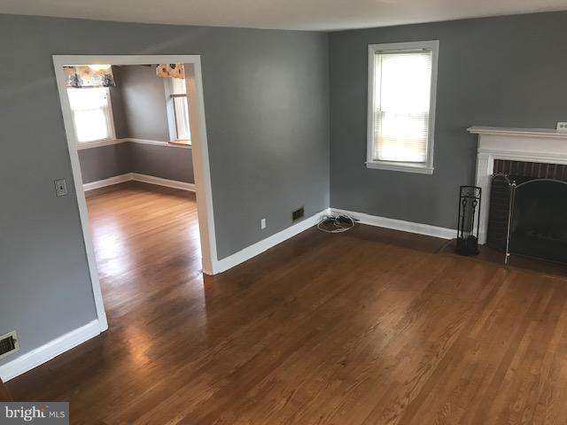 1001 Harwall Road Baltimore, MD 21207 - Photo 67 of 109 an empty room with wooden floor and windows