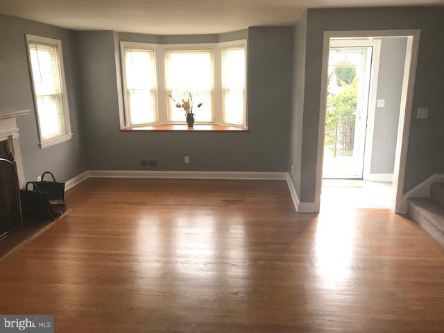 1001 Harwall Road Baltimore, MD 21207 - Photo 74 of 109 a view of an empty room with wooden floor and a window