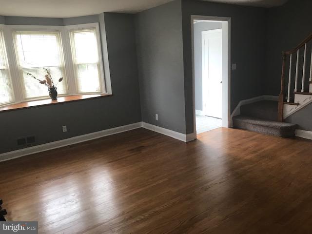 1001 Harwall Road Baltimore, MD 21207 - Photo 75 of 109 an empty room with wooden floor and windows