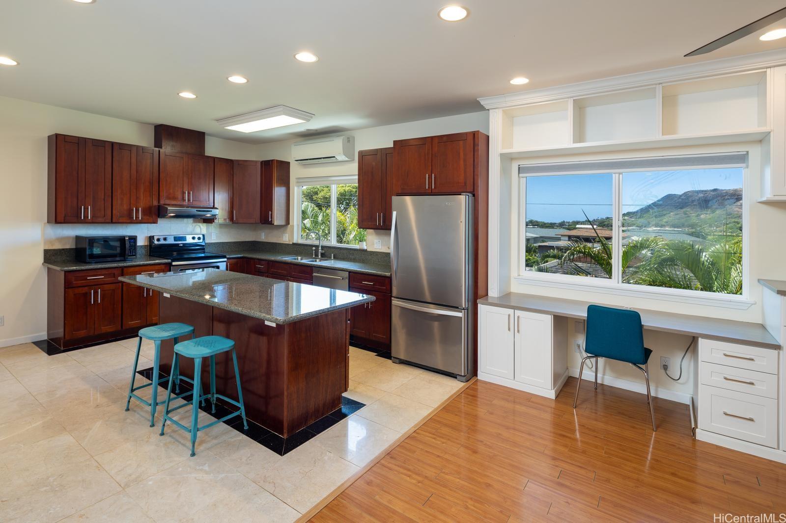 841 20th Avenue Honolulu, HI 96816 - Photo 4 of 17 a kitchen with stainless steel appliances granite countertop a refrigerator a sink a stove a dining table and chairs