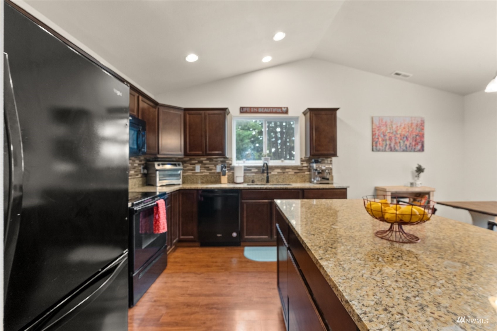 6320 192nd Lane Southwest Rochester, WA 98579 - Photo 12 of 30 a kitchen with stainless steel appliances granite countertop a sink and a refrigerator