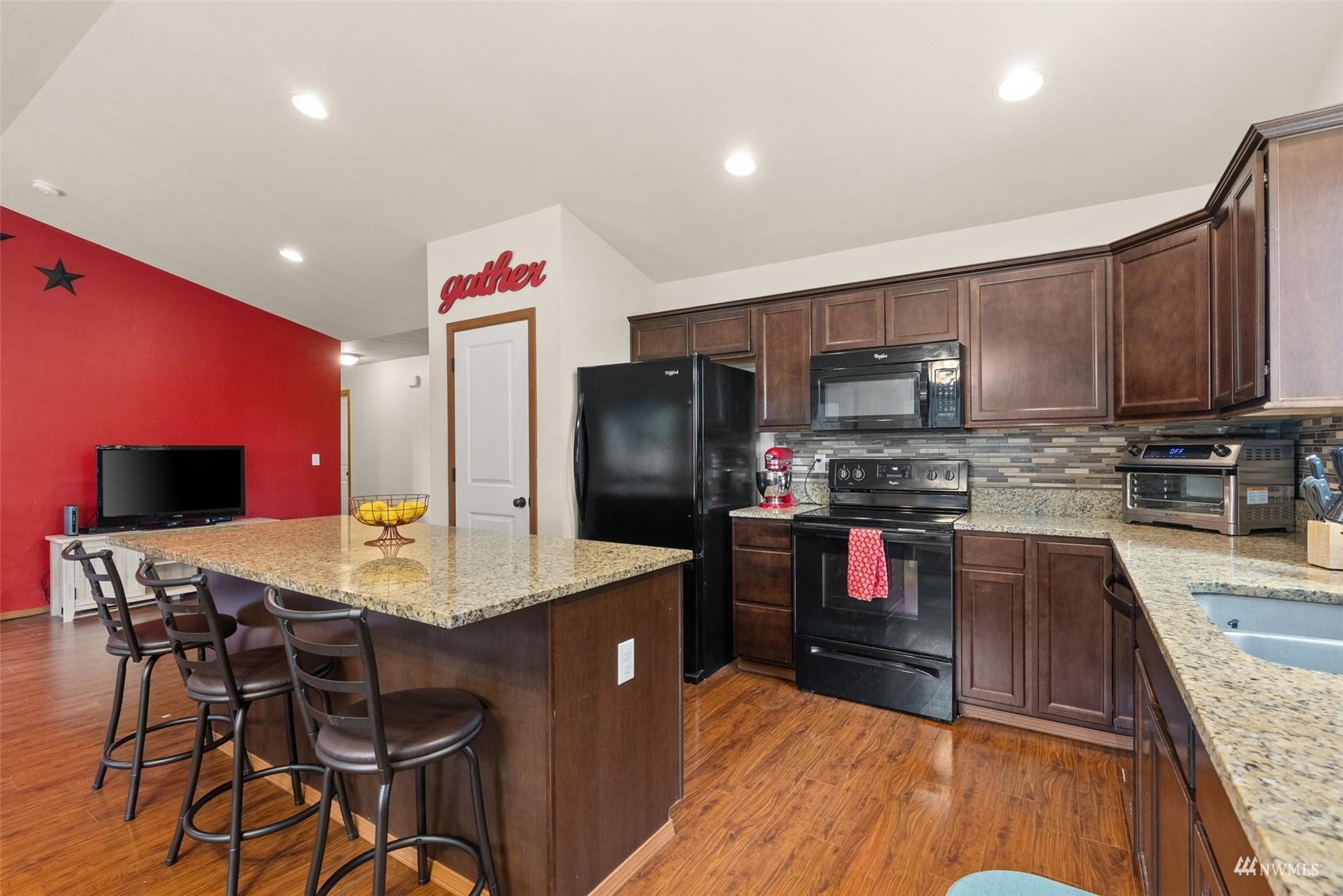 6320 192nd Lane Southwest Rochester, WA 98579 - Photo 13 of 30 a kitchen with stainless steel appliances kitchen island granite countertop a refrigerator a stove top oven a sink and dishwasher