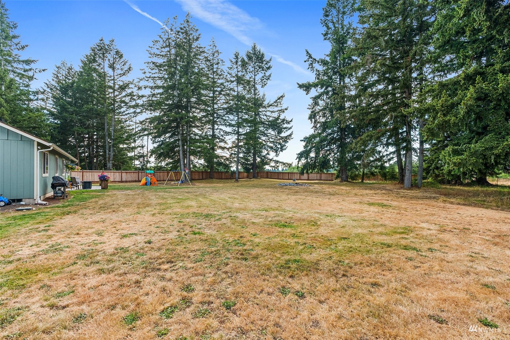 6320 192nd Lane Southwest Rochester, WA 98579 - Photo 26 of 30 a view of outdoor space with deck and trees