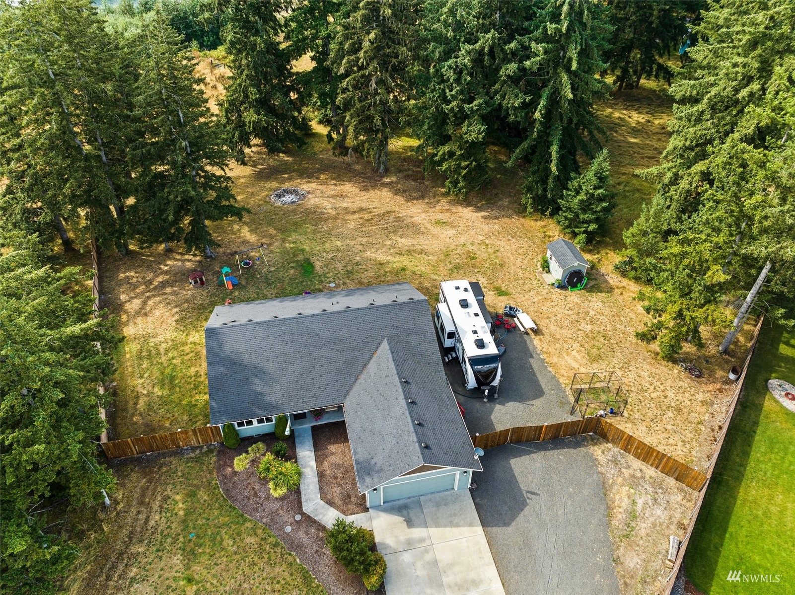 6320 192nd Lane Southwest Rochester, WA 98579 - Photo 4 of 30 an aerial view of a house with swimming pool and large trees