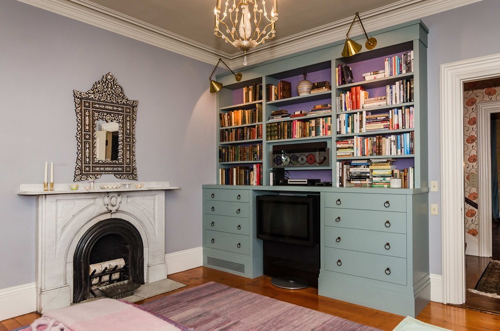 83 Elm Street Boston, MA 02130 - Photo 12 of 30 a living room with bookshelf and a fireplace