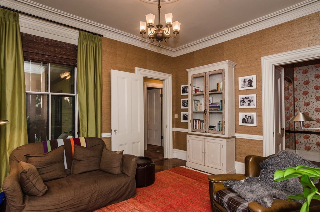 83 Elm Street Boston, MA 02130 - Photo 14 of 30 a living room with furniture a chandelier and kitchen view