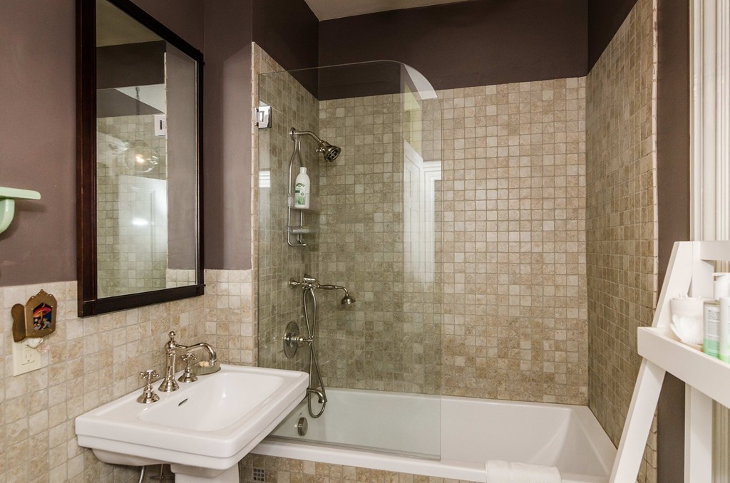 83 Elm Street Boston, MA 02130 - Photo 26 of 30 a bathroom with a sink shower and a mirror
