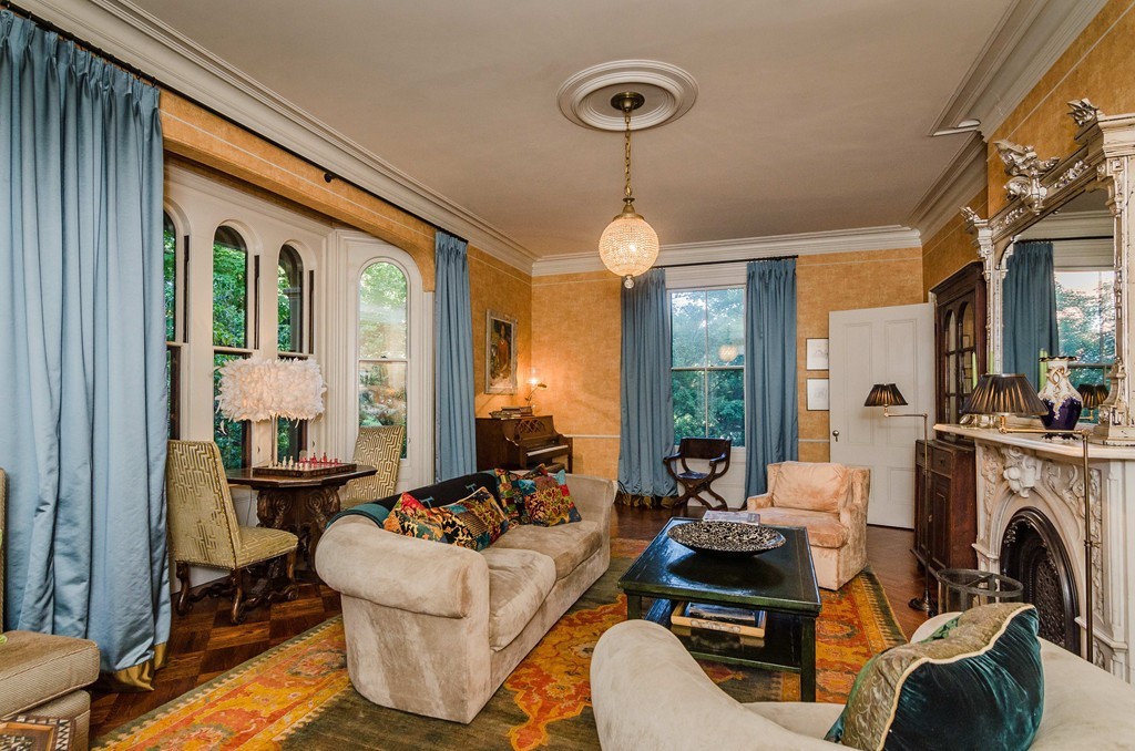 83 Elm Street Boston, MA 02130 - Photo 4 of 30 a living room with furniture fireplace and a large window