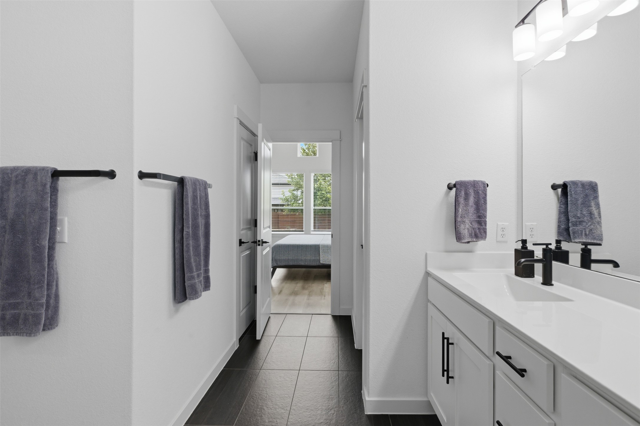 9001 Spire View Austin, TX 78744 - Photo 23 of 35 Contemporary bathroom vanity featuring a rectangular undermount sink, matte black faucet, and white countertop