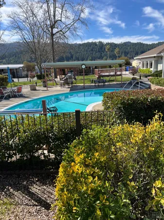 a view of swimming pool with outdoor seating and a garden
