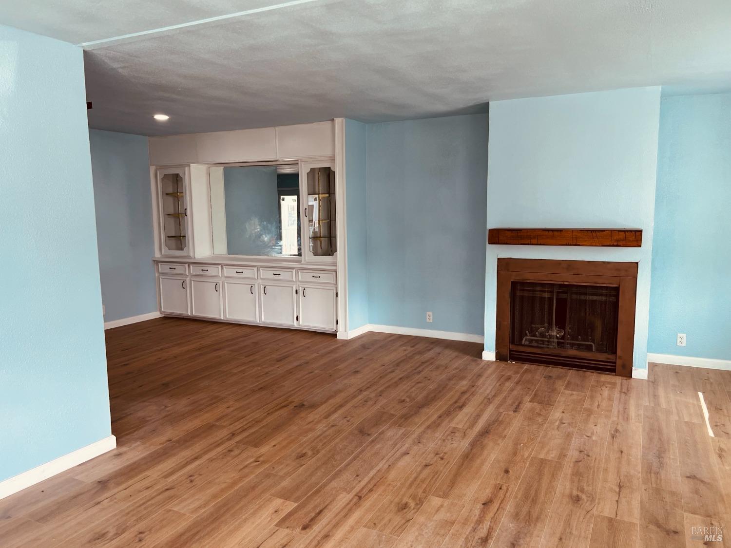 320 Chablis North Calistoga, CA 94515 - Photo 8 of 19 a view of empty room with wooden floor and fireplace