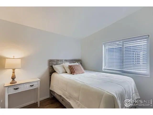 a bedroom with a bed and a night stand