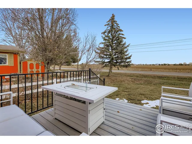 a view of a roof deck with wooden floor and fence