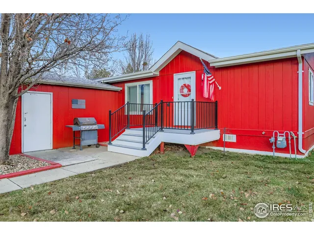 a view of swimming pool with red chairs