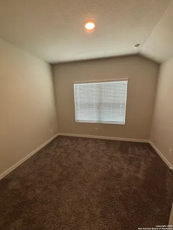 an empty room with a empty space and windows