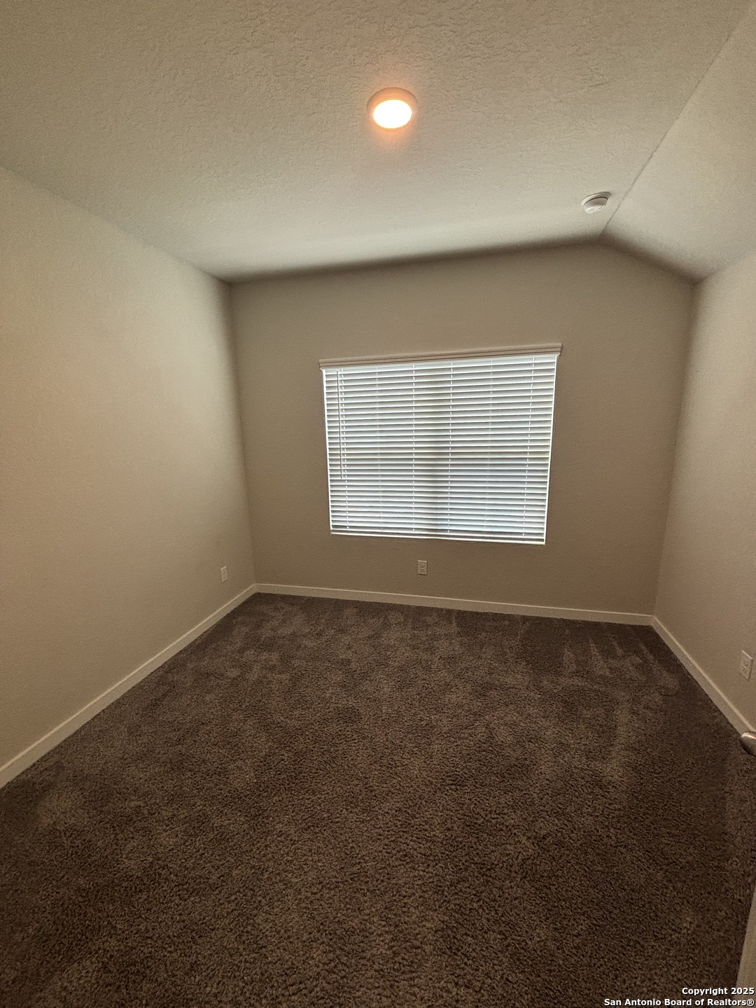 13311 Rowdy Cove, Unit 102 San Antonio, TX 78249 - Photo 18 of 19 an empty room with a empty space and windows