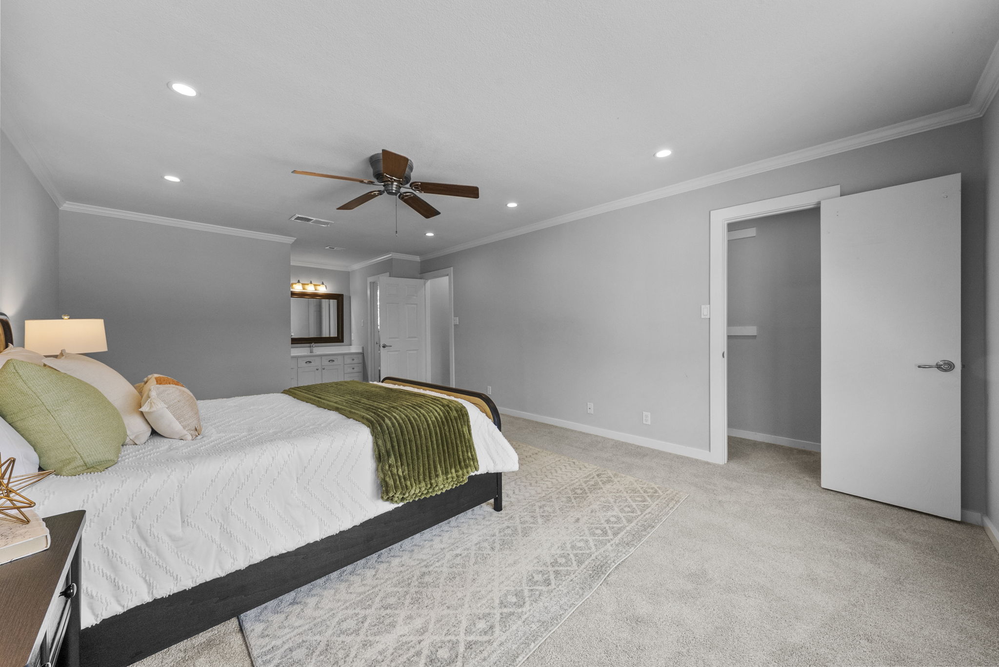 11405 Pyreneese Drive Austin, TX 78759 - Photo 14 of 37 a spacious bedroom with a bed and a chandelier