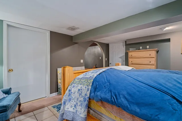 a bedroom with a bed and a dresser