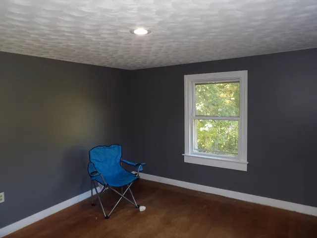 a view of a room with furniture and a window
