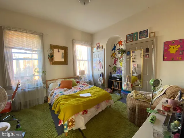 a living room with lots of furniture and a window