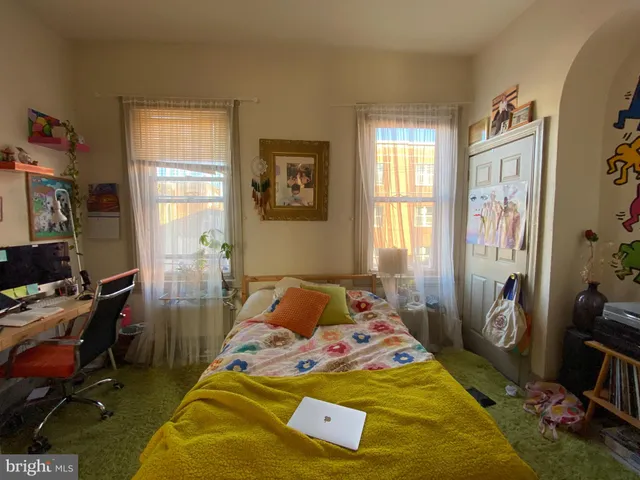 a bedroom with bed and a window