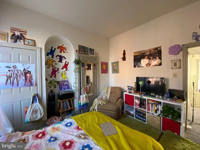 a bedroom with a bed mirror and window
