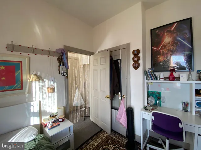 a bedroom with bed and a window