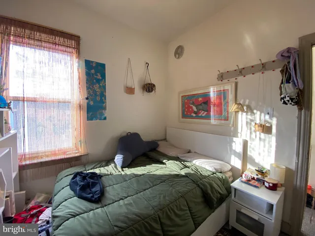 a bedroom with bed and book shelf
