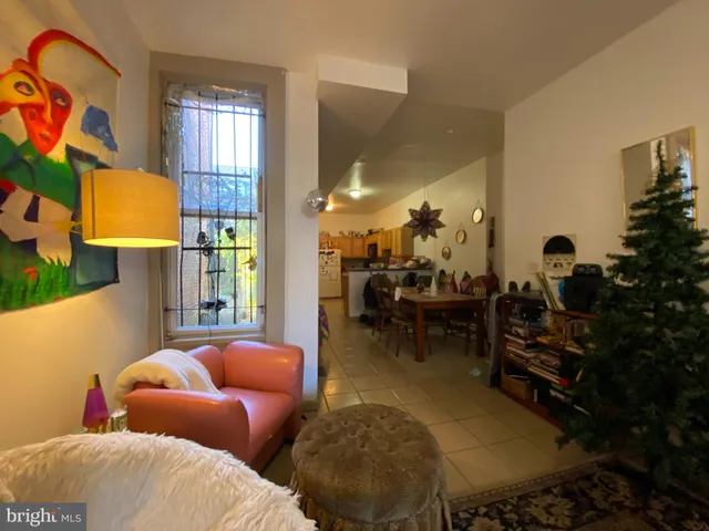 a bedroom with furniture and a potted plant