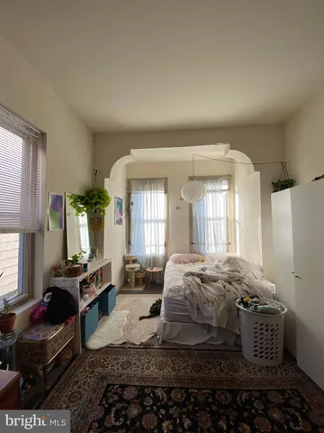 a bedroom with bed and wooden floor