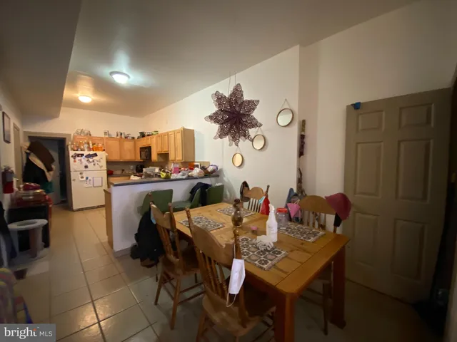 a view of a dining room with furniture and a chandelier
