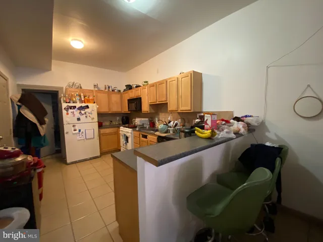 a kitchen with stainless steel appliances kitchen island granite countertop a sink and cabinets