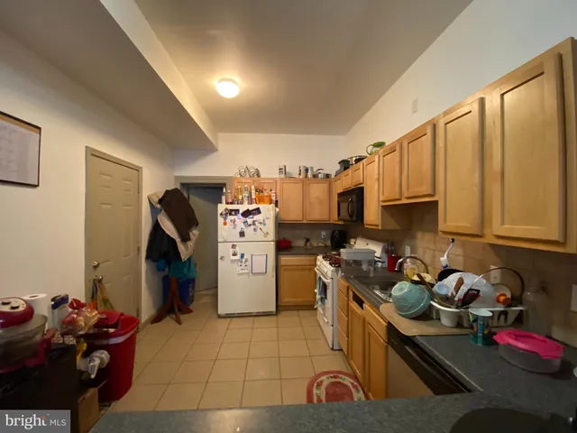 a kitchen with refrigerator and cabinets