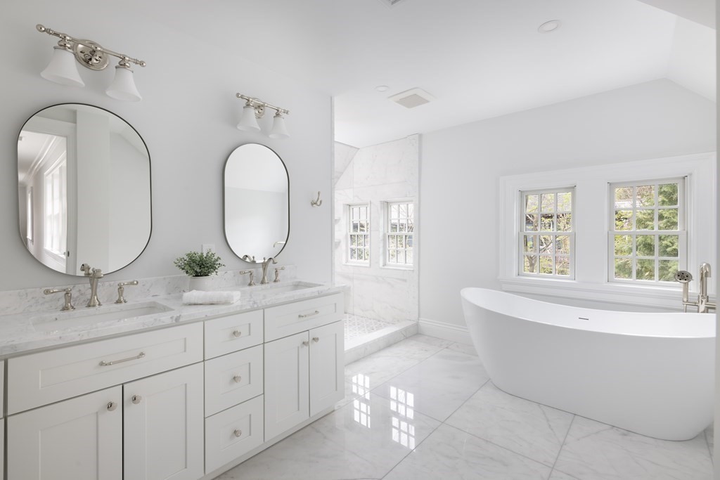 460 Walnut Street Brookline, MA 02445 - Photo 16 of 35 a spacious bathroom with double vanity a mirror a bathtub and window