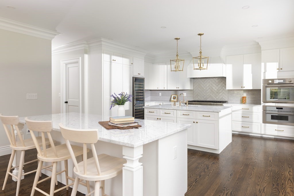 460 Walnut Street Brookline, MA 02445 - Photo 3 of 35 a kitchen with cabinets wooden floor and stainless steel appliances