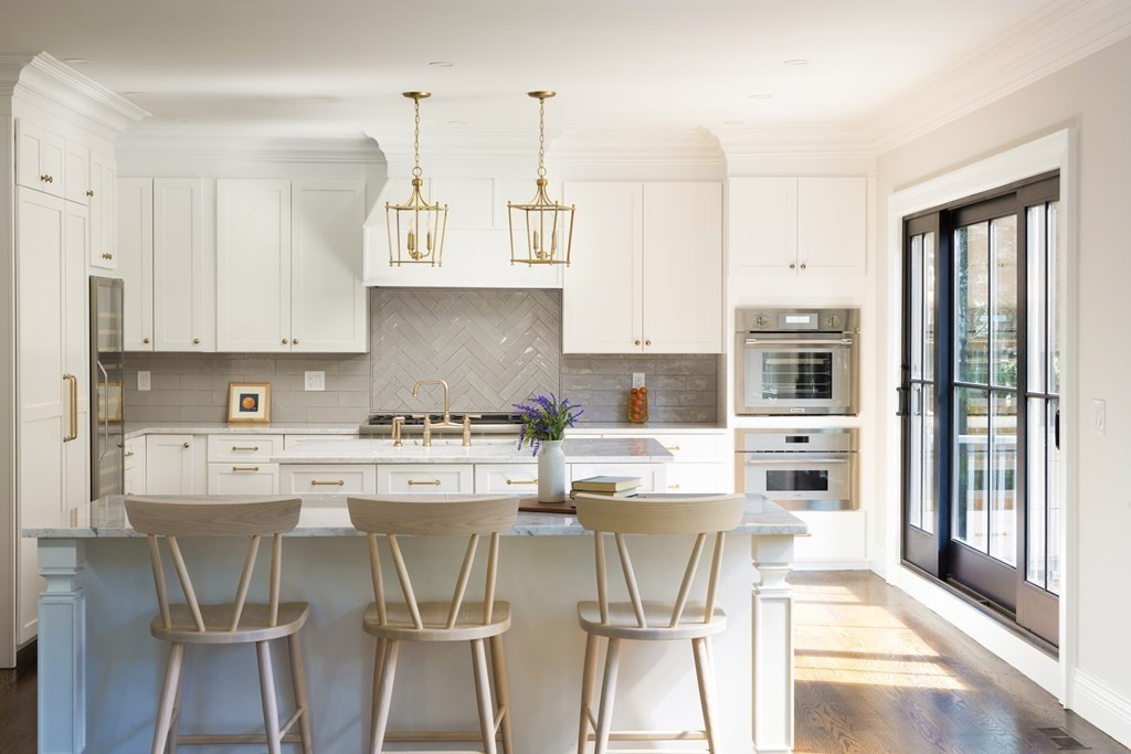 460 Walnut Street Brookline, MA 02445 - Photo 4 of 35 a kitchen with stainless steel appliances a stove a refrigerator and white cabinets