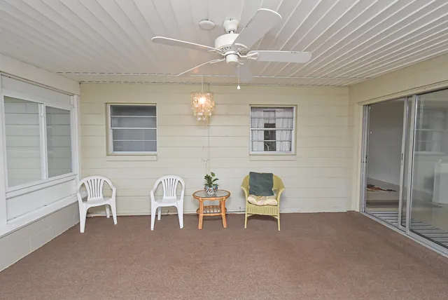a view of a room with a large window and a porch