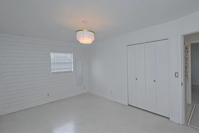 a bed room with a bed and a window