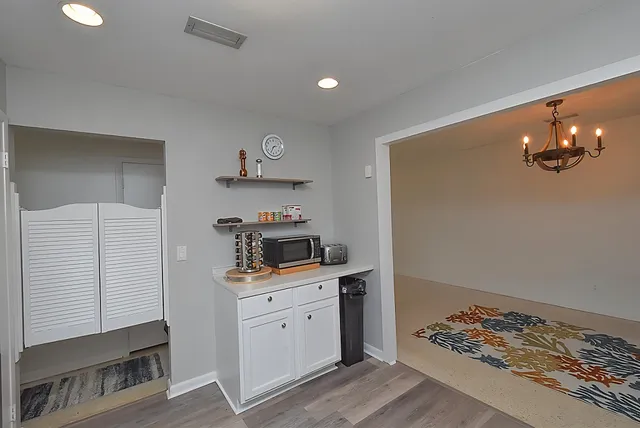 a kitchen with granite countertop white cabinets and stainless steel appliances