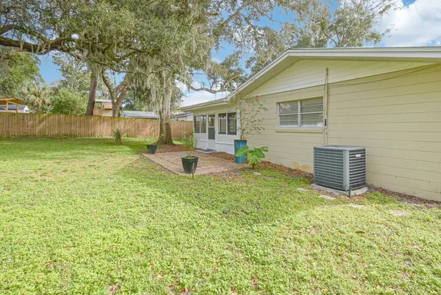 a view of a house with backyard and sitting area