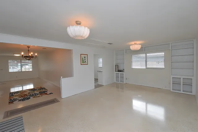 a view of a room with wooden floor and white walls