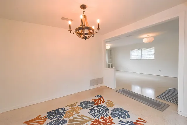 a view of a room with wooden floor