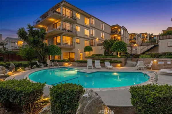 a swimming pool with outdoor seating and yard