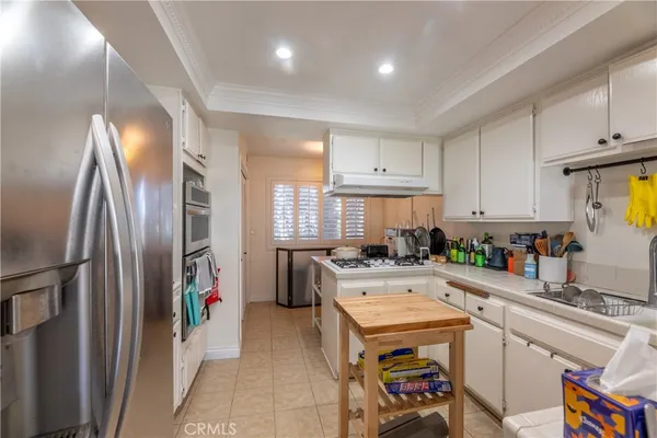 a kitchen with appliances a sink and cabinets