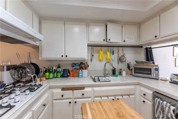 a kitchen with stainless steel appliances a refrigerator and a stove top oven