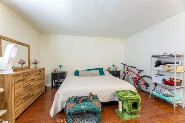 a bed room with furniture and a wooden floor
