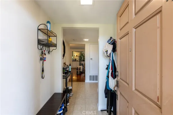 a view of a hallway with wooden floor and entryway