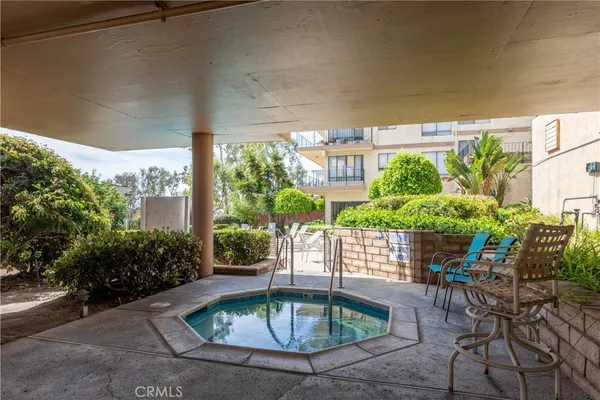 a view of a swimming pool with outdoor seating