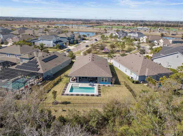 an aerial view of residential houses with outdoor space