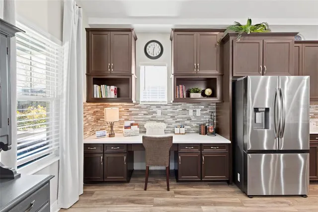a kitchen with stainless steel appliances granite countertop a refrigerator and a stove